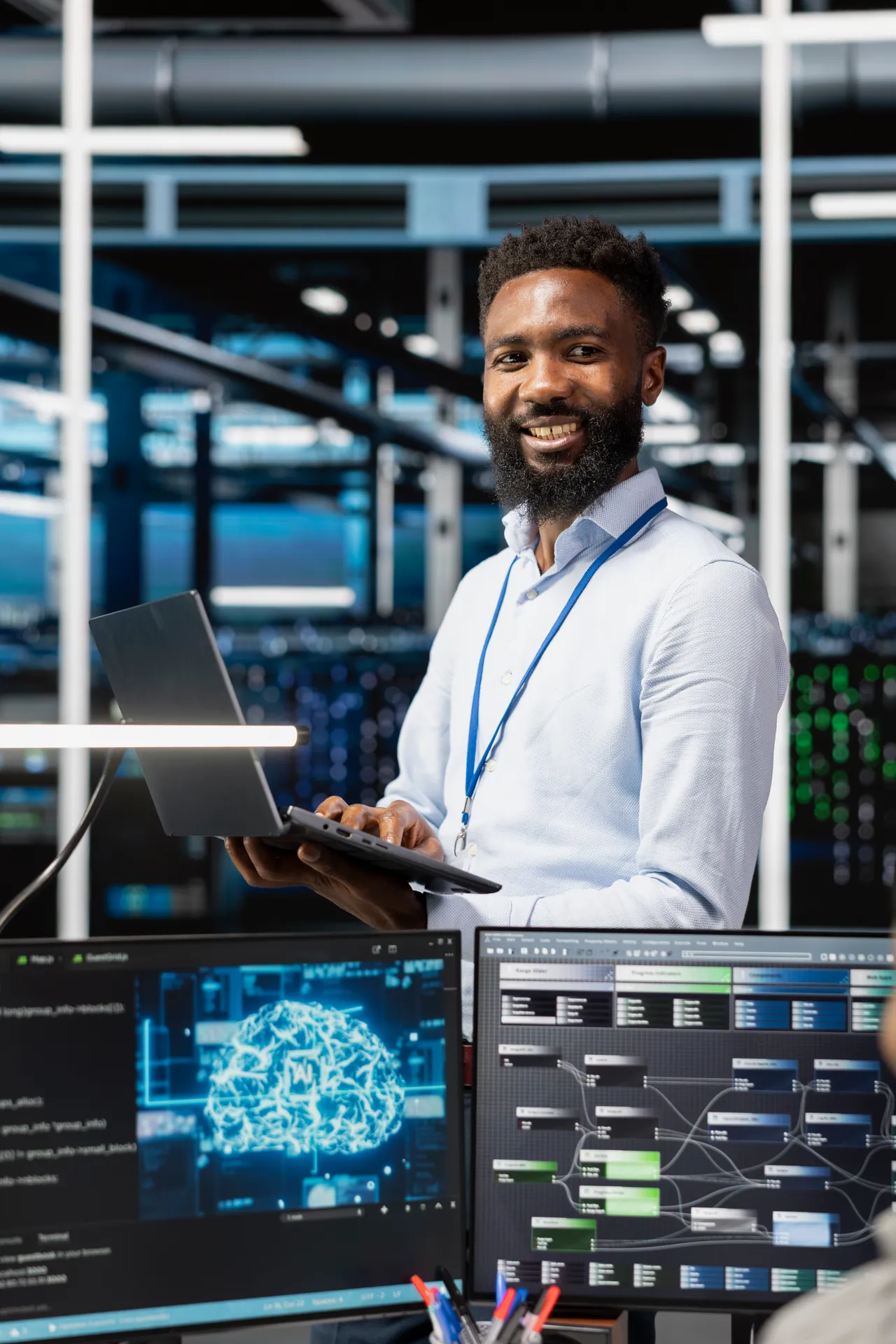 Technology professional with a laptop in a server facility