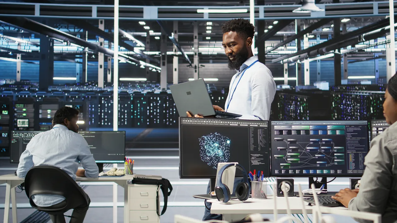 Software development workspace with engineers and system diagrams