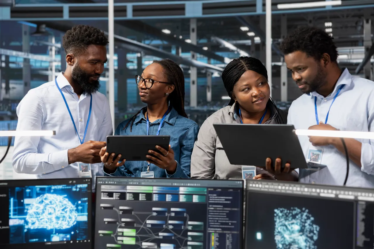 Technology professionals collaborating around digital systems